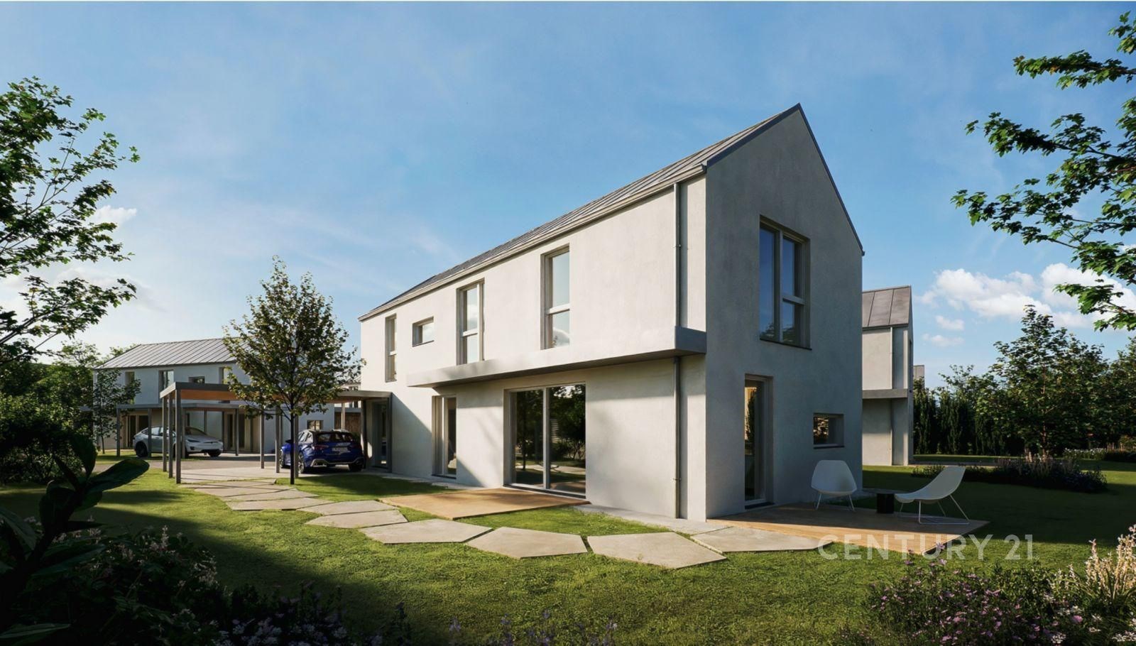 Moderní rodinný dům s velkými okny, minimalistickým designem a prostornou zahradou, nacházející se v klidné rezidenční oblasti.