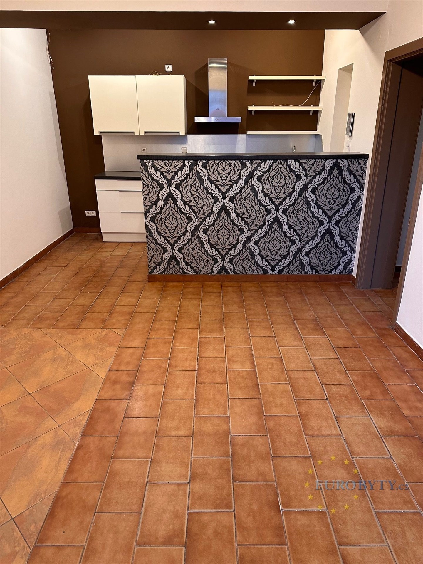 Kuchyň s moderním obkladem, dlažbou a vestavěnými skříněmi, ideální pro rekonstrukci nebo modernizaci.