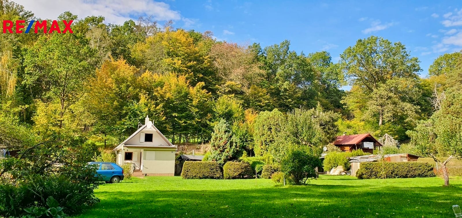 Pohled na chatu a zahradu od vjezdové brány