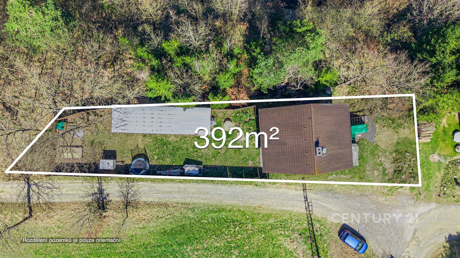 Letecký pohled na pozemek o rozloze 392 m² s rodinným domem a zahradou, obklopený přírodou, vhodný pro rekreační nebo trvalé bydlení.