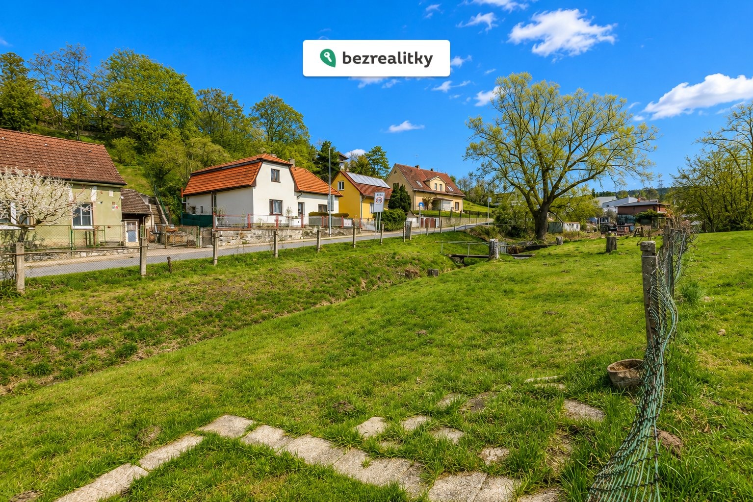 1779783930-wide-bright-daylight-rural-village-scene-a-grassy